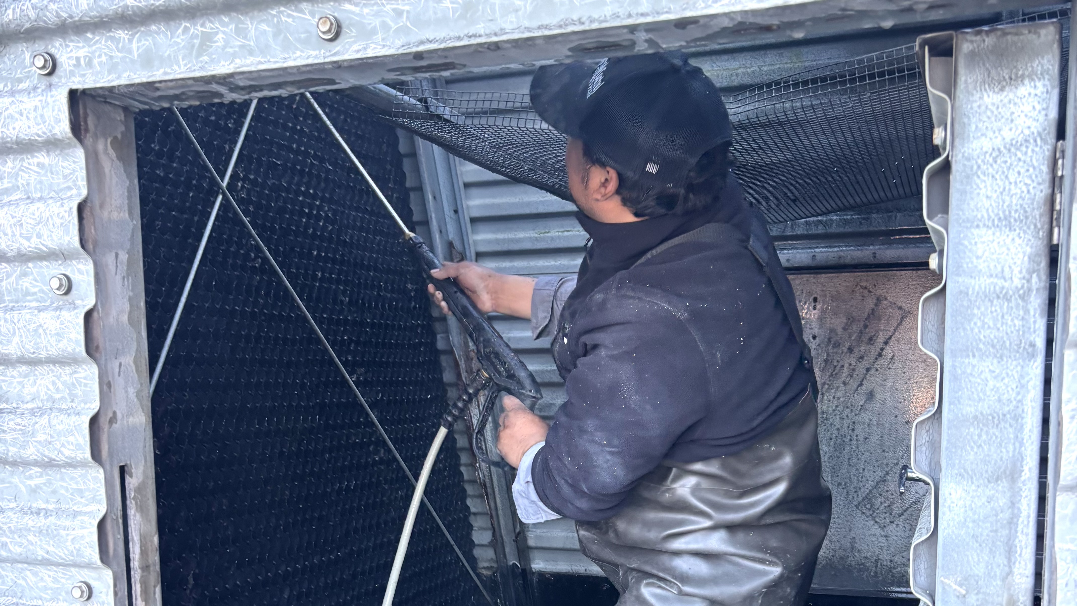 Technician cleaning commercial coils