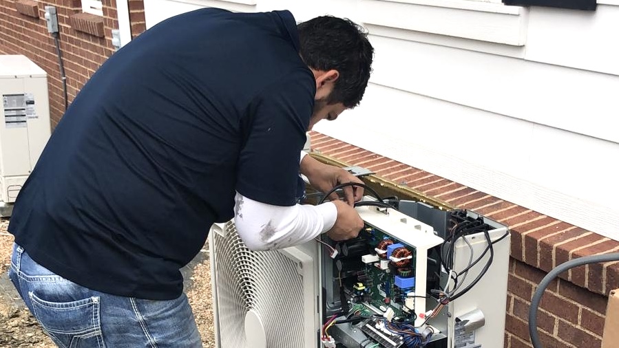Technician repairing HVAC unit